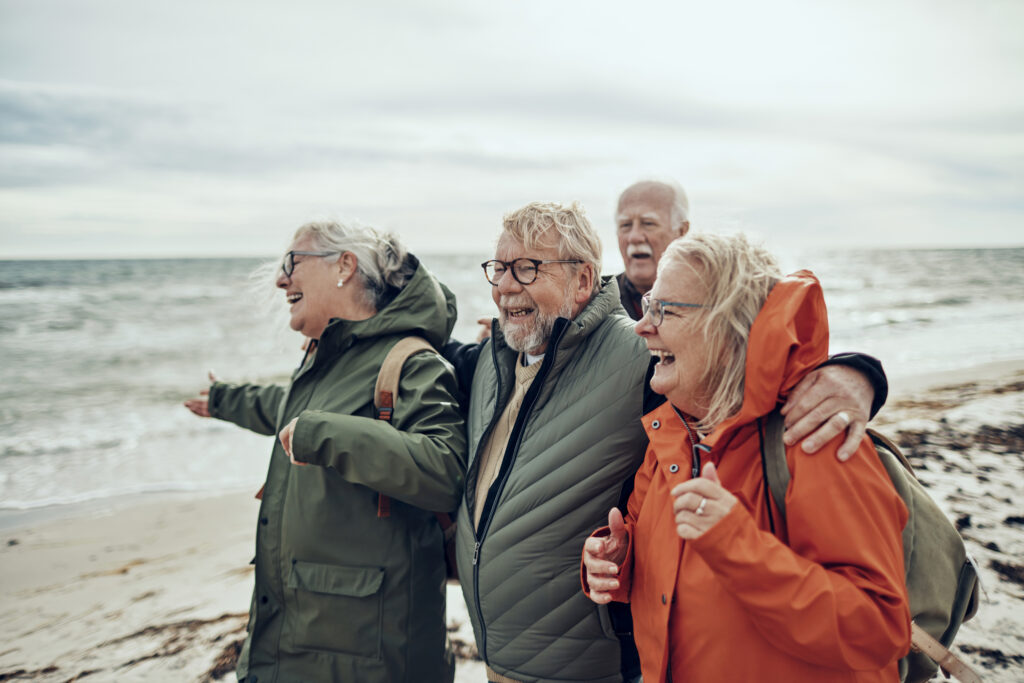 Group of people walking on the beach on a windy day